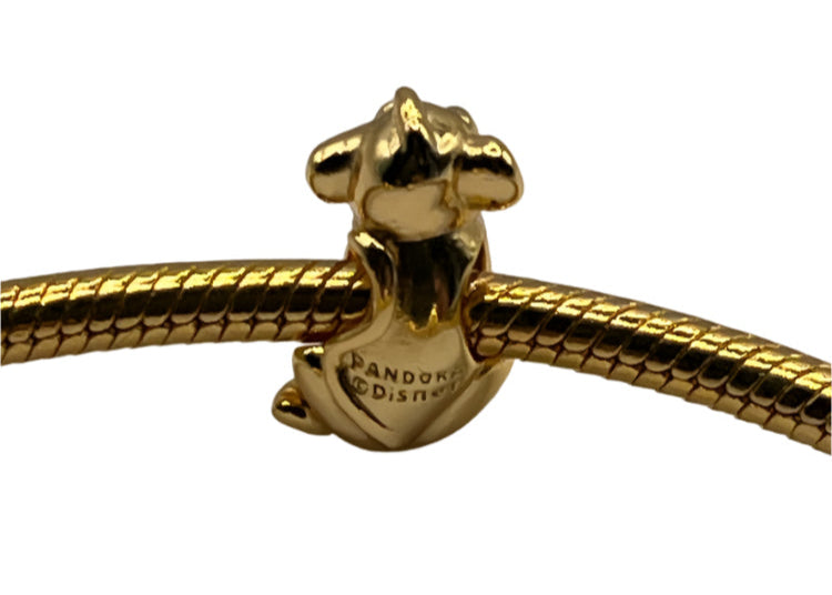 Gold charm with 'Pandora Disney' engraving on a white background