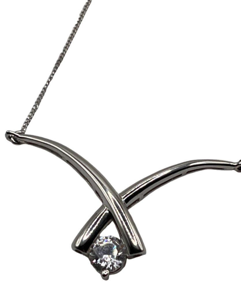 Silver necklace with a diamond pendant on a white background