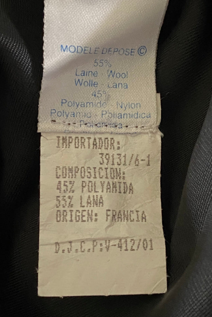 Textile label with fabric composition and import details on a dark background