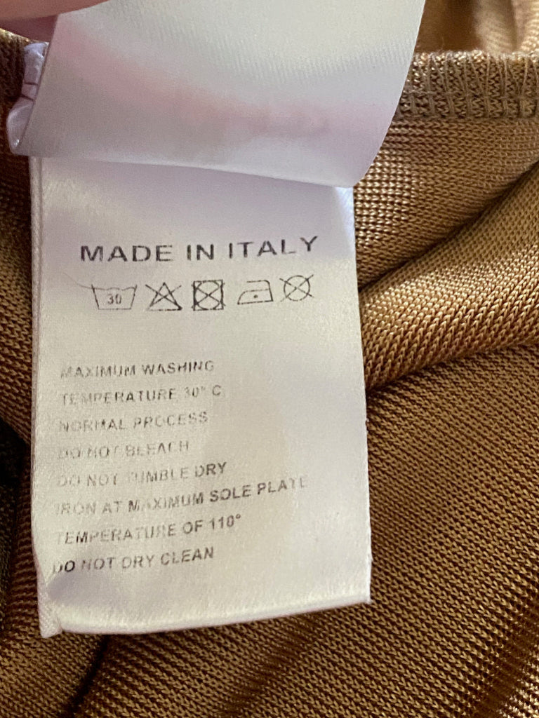 Clothing label with washing instructions on a gold fabric background