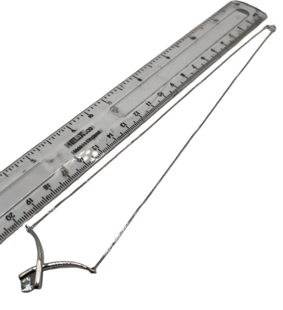 White Gold Necklace with a ruler for scale on a white background