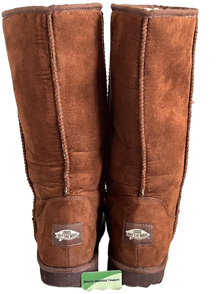 Pair of Vans brown suede boots with visible brand labels on a white background