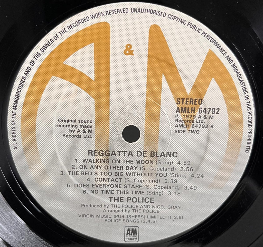 Vinyl record label with 'A&M' logo and track listing for 'Reggatta De Blanc' Side 2 by The Police.