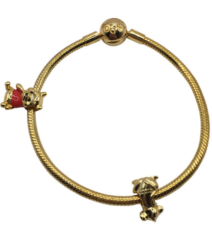 Gold bracelet with two charms on a white background