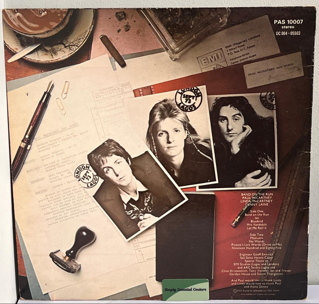 Wings, Band On The Run, Vinyl record cover with black and white photos and text on a textured surface