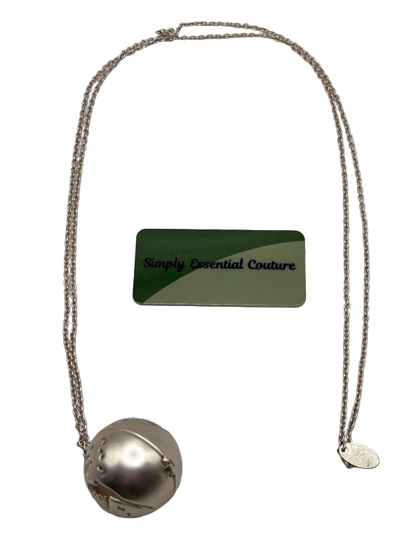 Necklace with a spherical pendant and a smaller heart-shaped pendant, displayed on a gray background with a 'Simply Essential Couture' card.