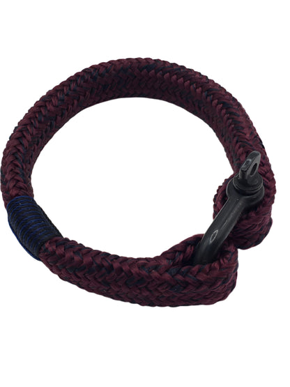 Braided purple and black bracelet on a white background