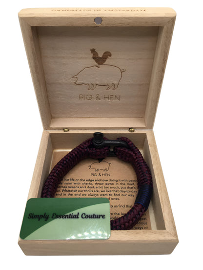Wooden box with a bracelet and a card inside, featuring 'Pig & Hen' branding.