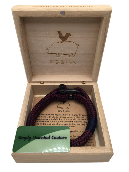 Wooden box with a bracelet and a card inside, featuring 'Pig & Hen' branding.