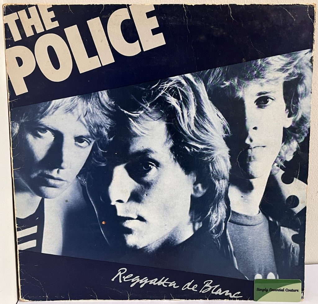 Vinyl record cover for 'The Police' album 'Reggatta de Blanc' with black and white portrait of band members.