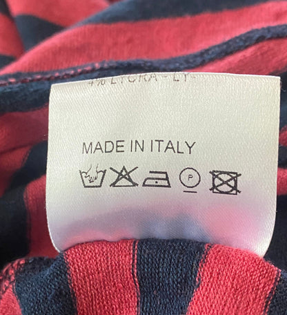 Clothing label with 'Made in Italy' text on a red and blue striped fabric background