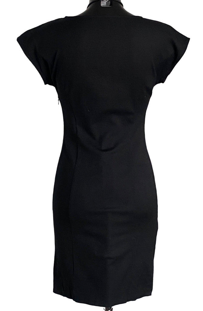Black Moschino dress on a mannequin against a white background
