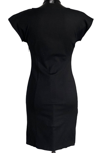 Black Moschino dress on a mannequin against a white background