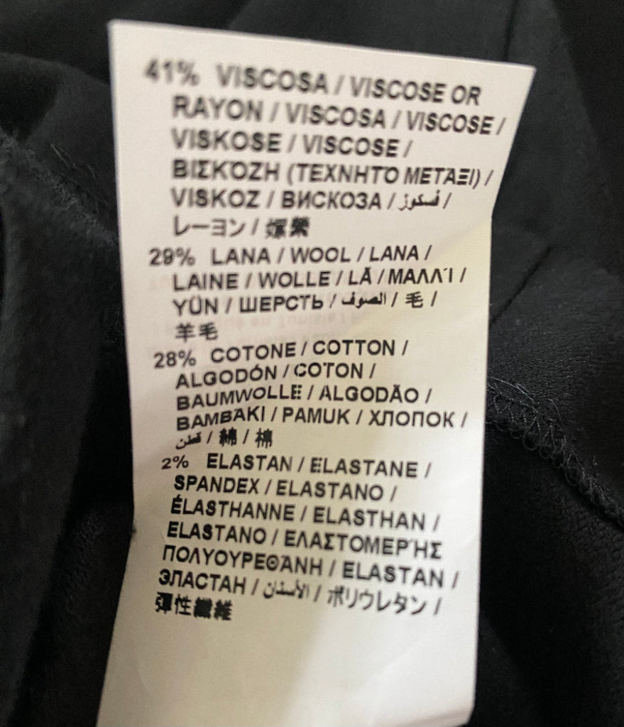 Clothing label with fabric composition details on a black background