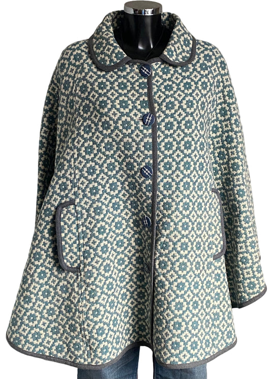 TREFRIW Patterned cqpe on a mannequin against a white background