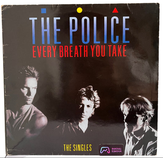 Album cover of 'Every Breath You Take' by The Police with black and white portraits on a dark background.