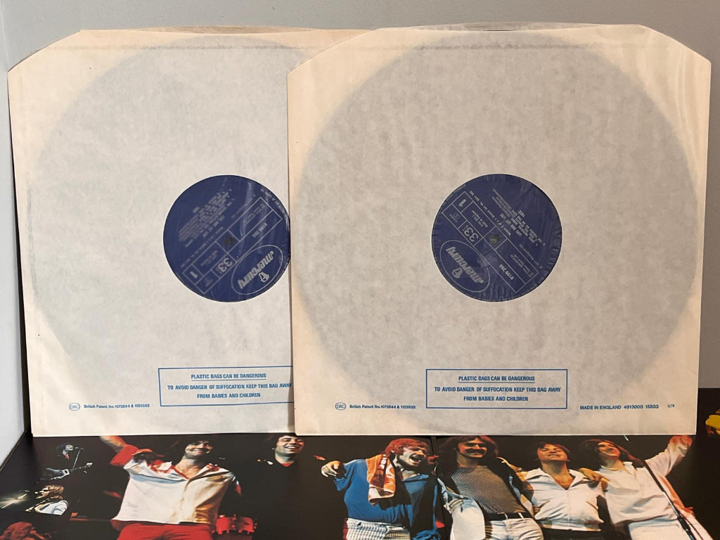 10CC Vinyl record set with white sleeves and a colorful album cover at the bottom.