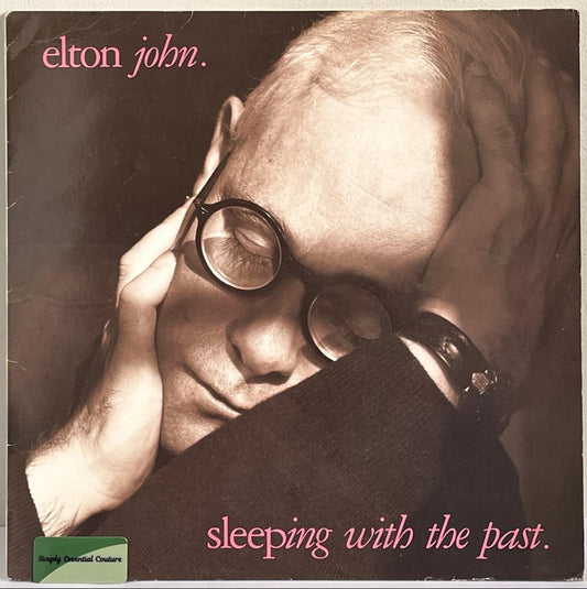 Album cover of Elton John's 'Sleeping with the Past' featuring a sepia-toned portrait.